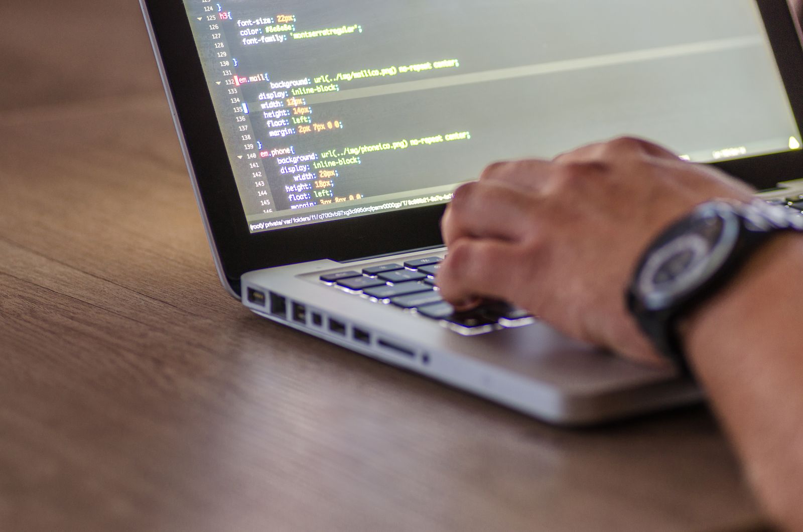 Hands typing code on a laptop while patching servers after the critical PHP vulnerability