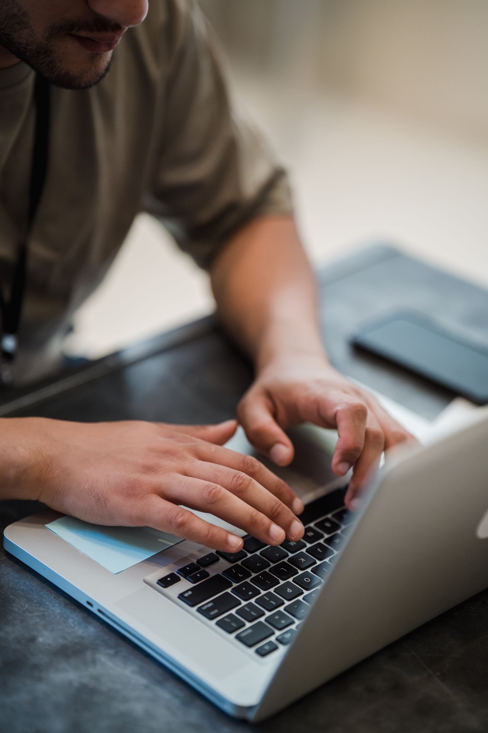 Close-up of hands typing on a laptop keyboard while working on how to rank on Google in Syria