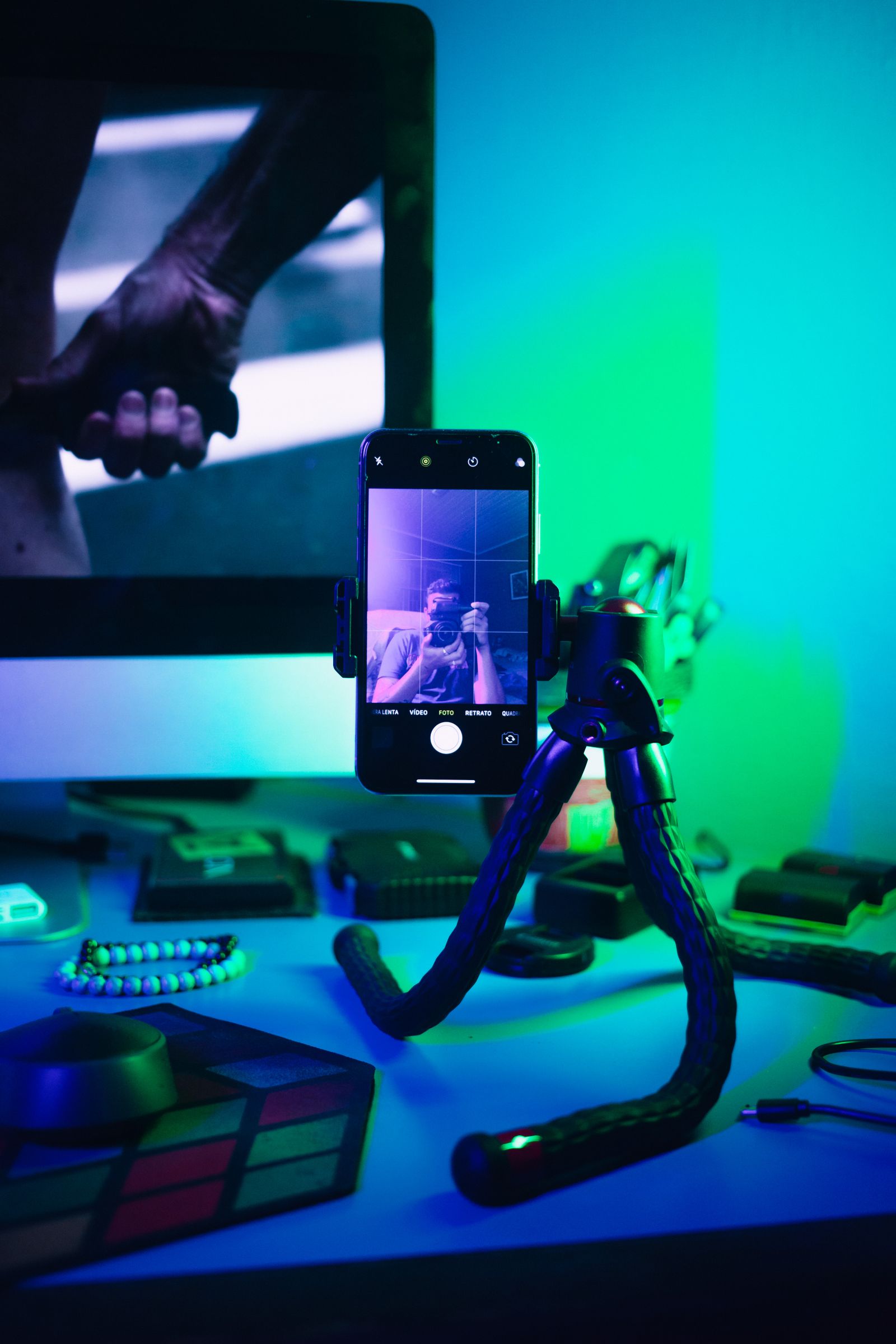 Smartphone on a holder at a desk, part of the content production behind social media management cost in Syria